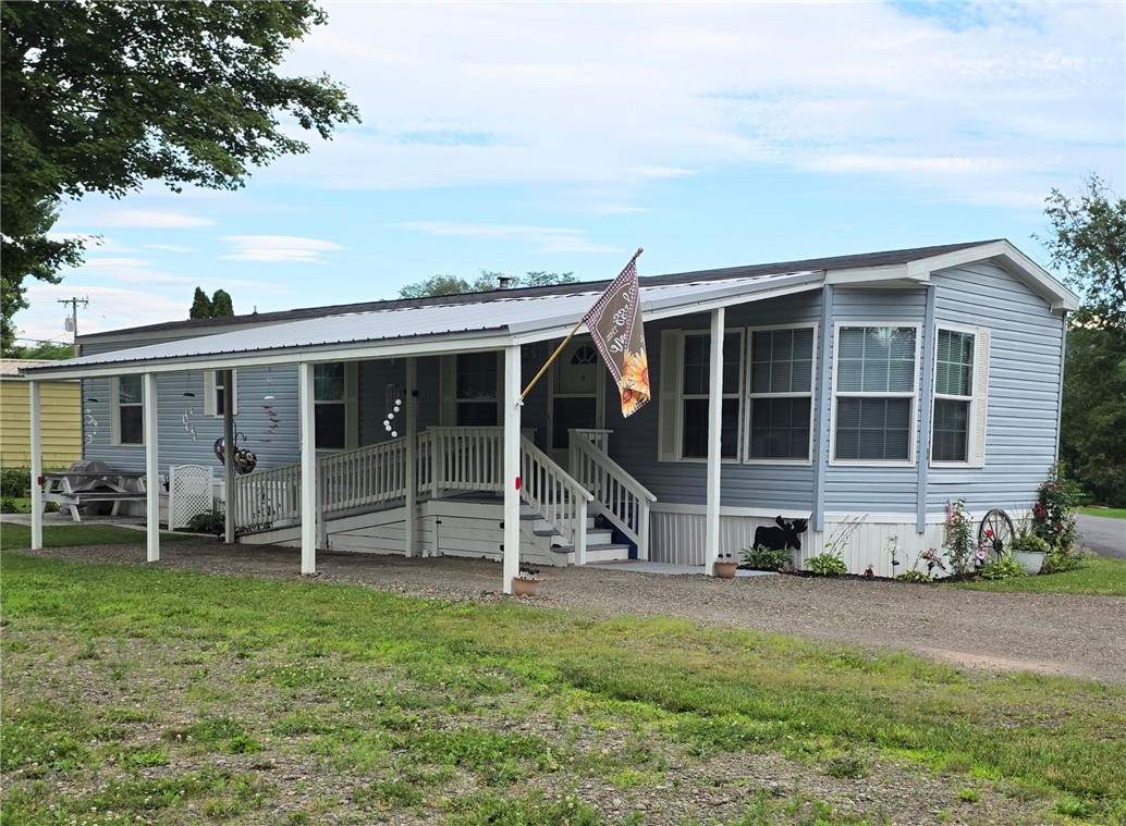 Front with carport and covered porch