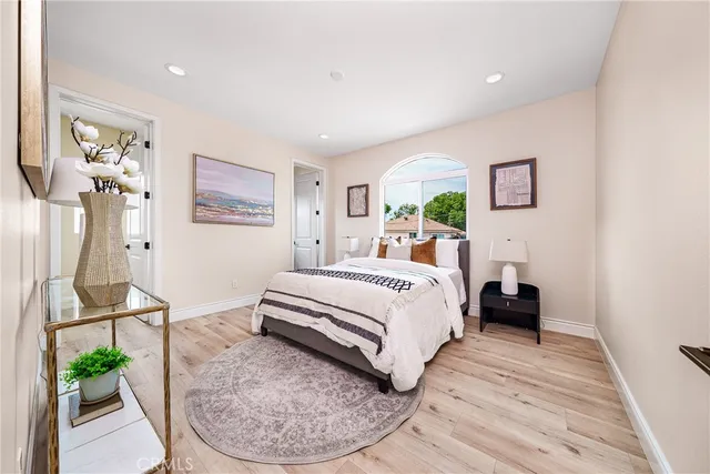 a bedroom with a bed and wooden floor