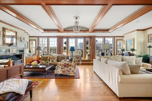 a living room with furniture fireplace and floor to ceiling window