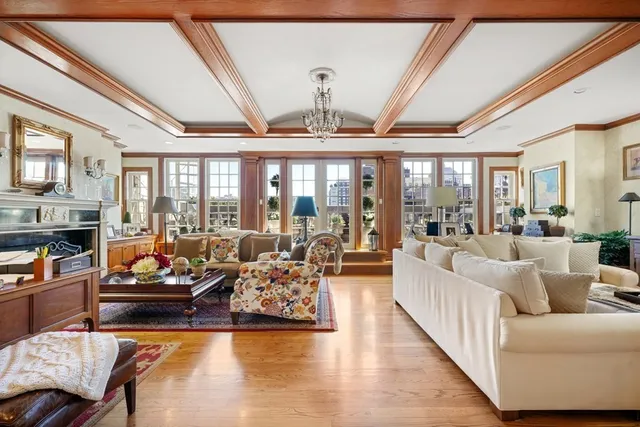 a living room with furniture fireplace and floor to ceiling window