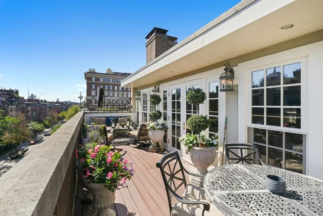 a view of a chairs and table in patio of the house