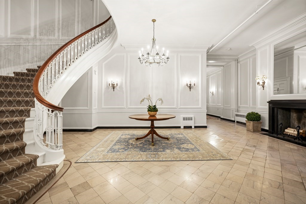95 Beacon Street, Unit PH Boston, MA 02108 - Photo 13 of 14 a living room with wooden floor and a chandelier