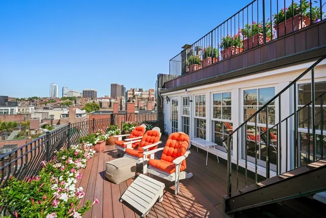 a view of a balcony with outdoor seating