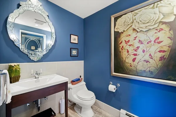 a bathroom with a toilet a sink and a mirror