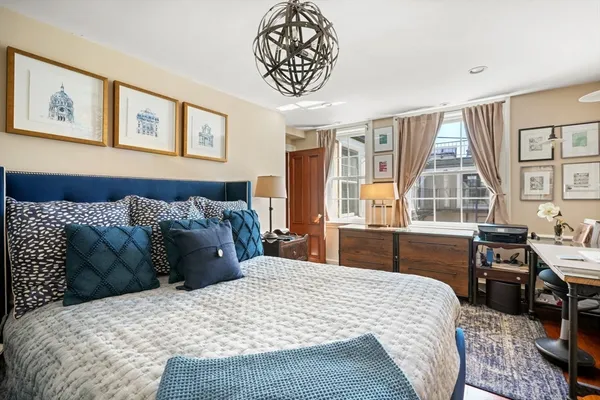 a bedroom with a large bed and a window