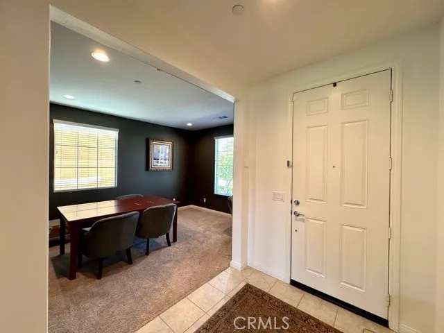 a living room with furniture pool table and a flat screen tv