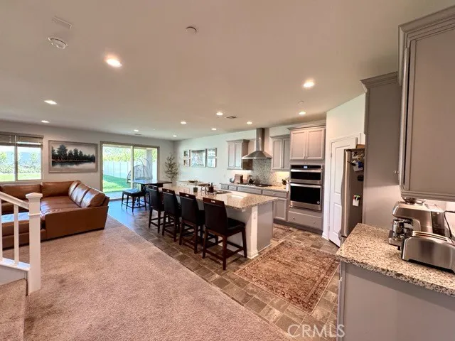 a large kitchen with lots of counter space a sink and chairs