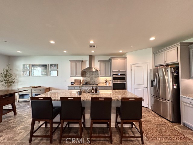 34110 Big Sur Drive Murrieta, CA 92563 - Photo 15 of 58 a kitchen with a dining table chairs and refrigerator