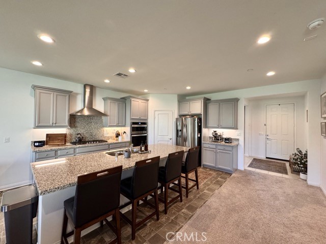 34110 Big Sur Drive Murrieta, CA 92563 - Photo 16 of 58 a large kitchen with lots of counter space a sink and chairs