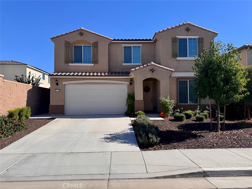 34110 Big Sur Drive Murrieta, CA 92563 - Photo 2 of 58 a front view of a house with a yard and garage