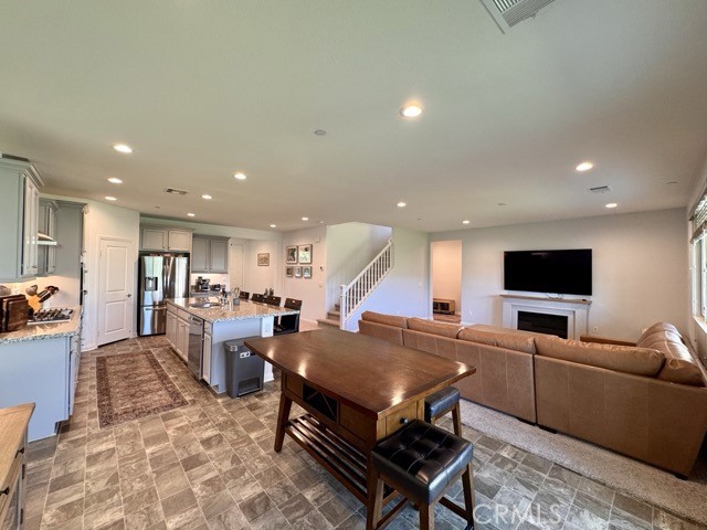 34110 Big Sur Drive Murrieta, CA 92563 - Photo 21 of 58 a living room with furniture a flat screen tv and kitchen view