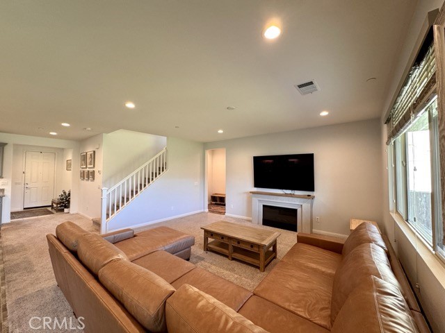 34110 Big Sur Drive Murrieta, CA 92563 - Photo 22 of 58 a living room with furniture flat screen tv and a fireplace