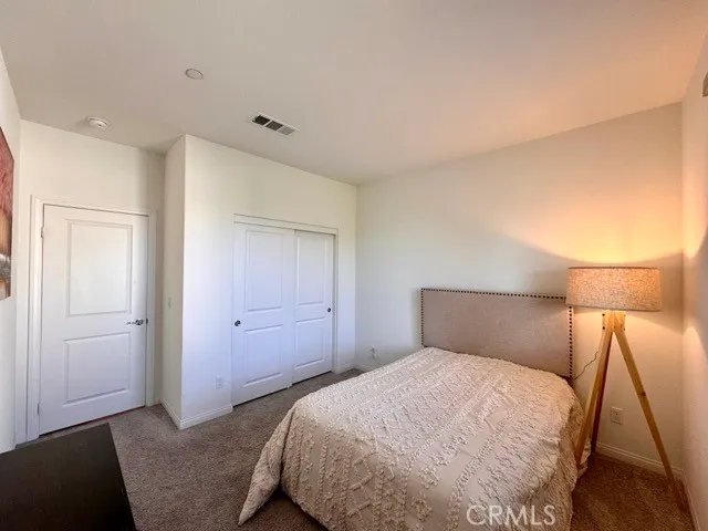a bedroom with furniture and a window