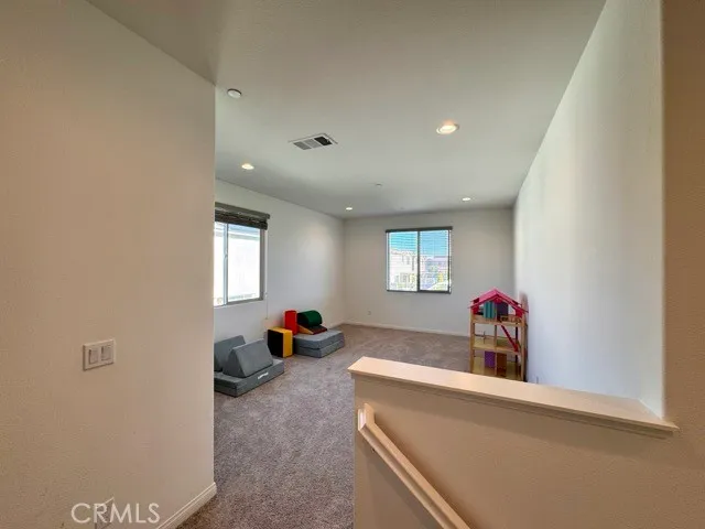 a living room with a rug and a flat screen tv
