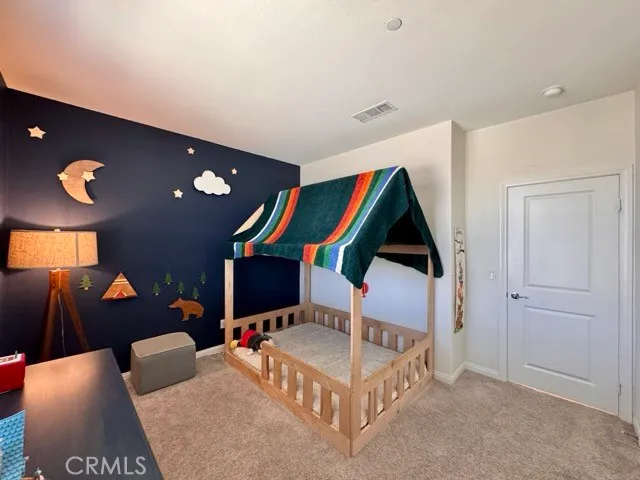 a bathroom with a double vanity sink a mirror and a toilet