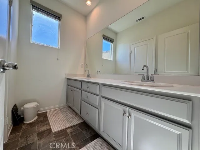 a bathroom with a shower and a glass door