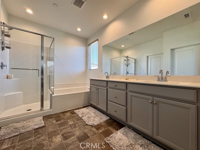 34110 Big Sur Drive Murrieta, CA 92563 - Photo 50 of 58 a bathroom with a double vanity sink a mirror and a bathtub