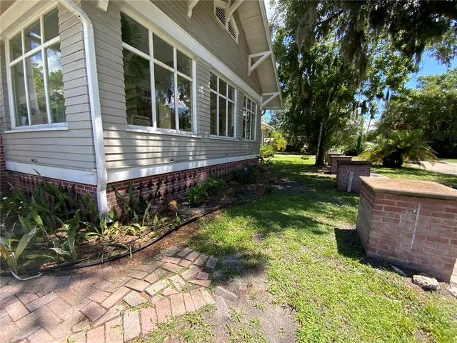 a living room with patio furniture and a fireplace
