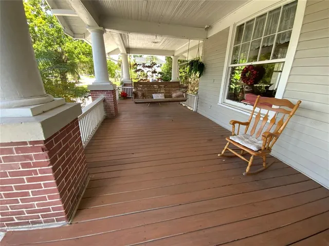 a view of a hallway with entryway wooden floor and front door