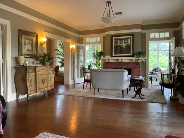 a large white kitchen with a black white checkered floor