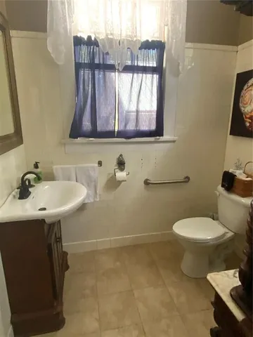 a bathroom with a toilet and a mirror