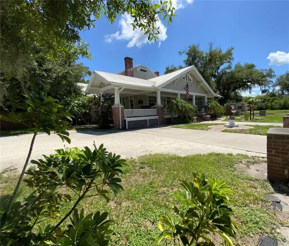 a view of a house with swimming pool and a yard