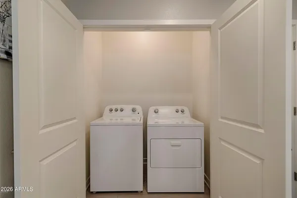 a view of a livingroom with furniture and a gym equipment