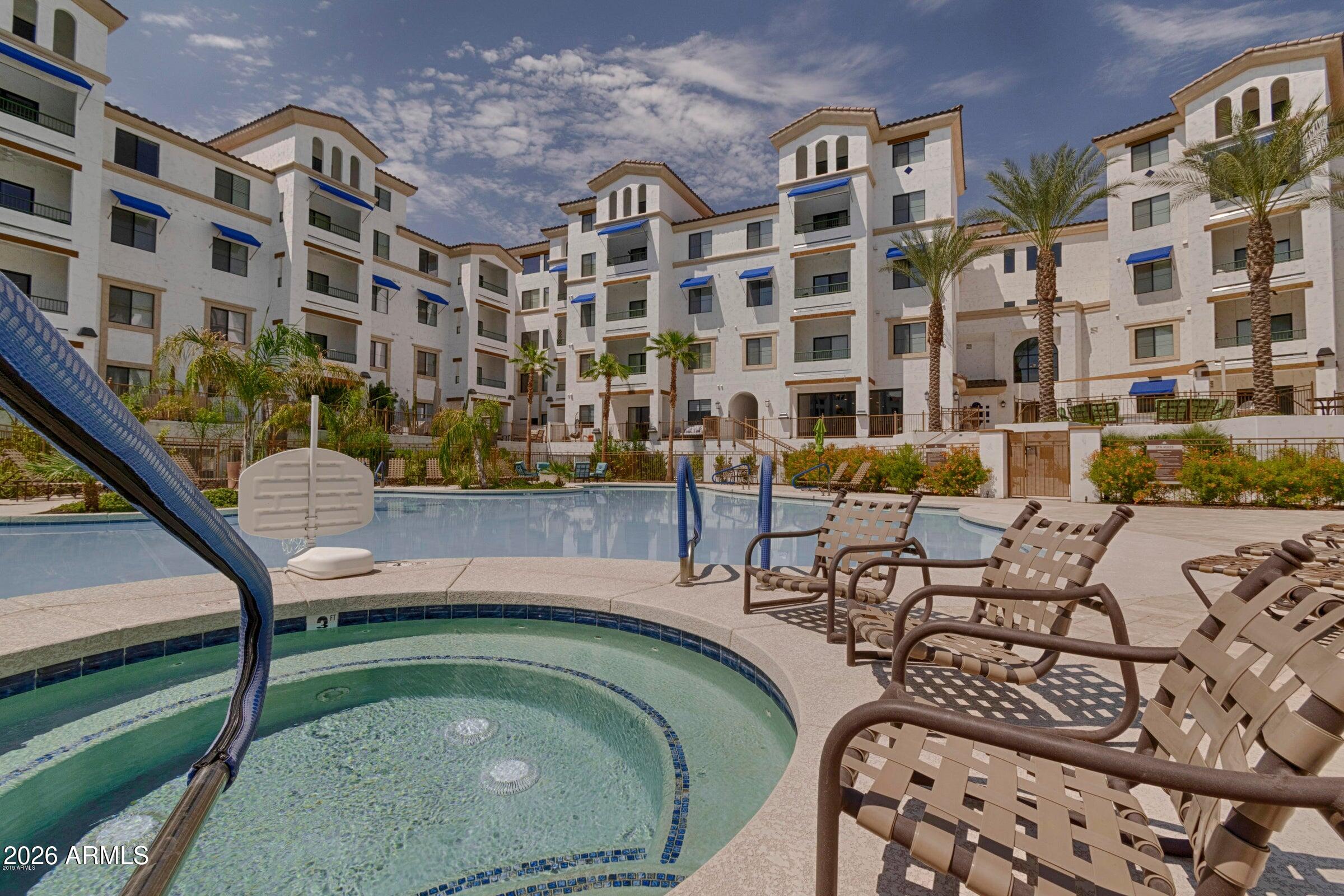 2511 West Queen Creek Road, Unit 260 Chandler, AZ 85248 - Photo 22 of 24 a view of swimming pool with outdoor seating and city view