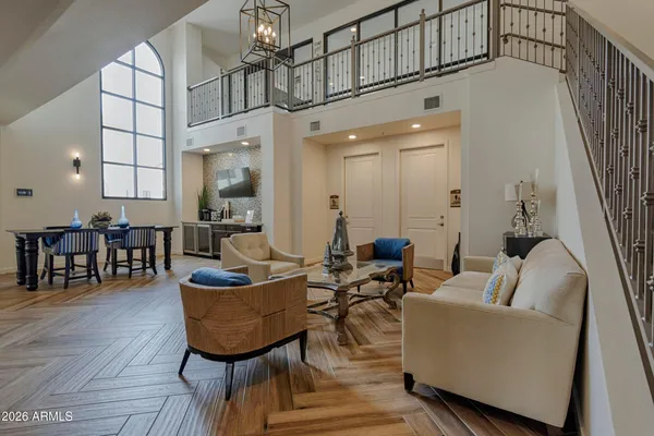 a living room with fireplace furniture and a chandelier