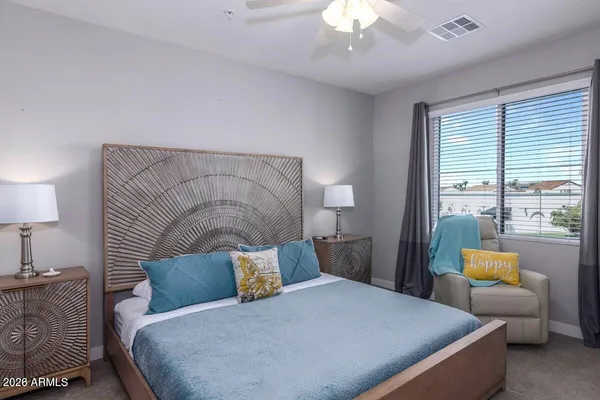 a bedroom with a bed and a lamp