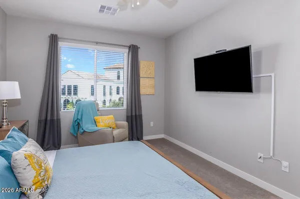 a bedroom with furniture and flat screen tv