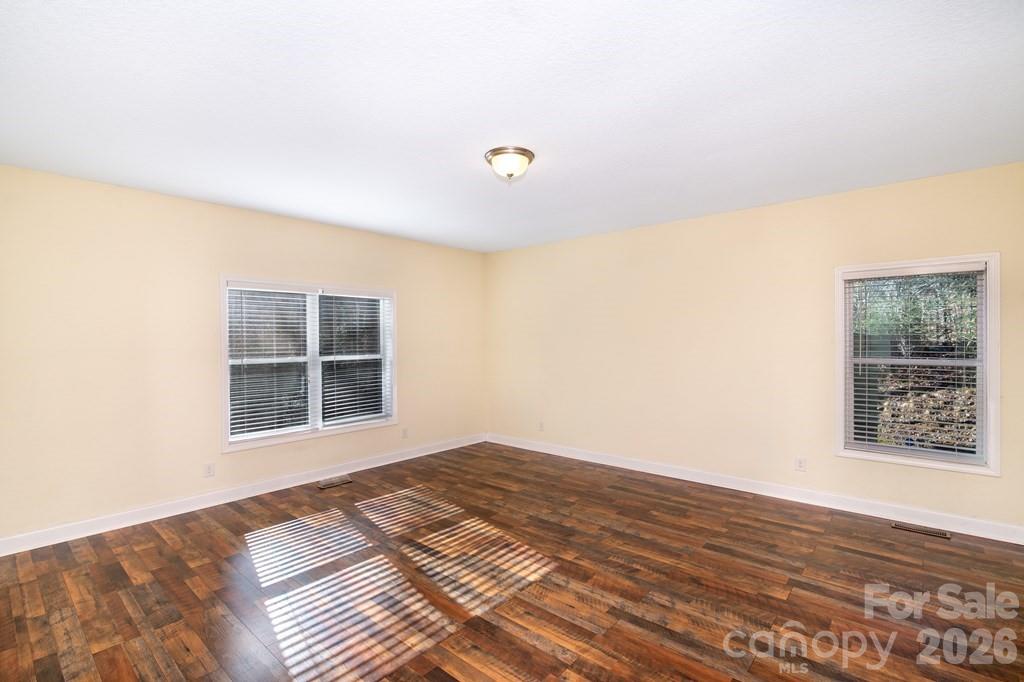12 Chigger Ridge Road Sylva, NC 28779 - Photo 12 of 28 a view of an empty room with wooden floor and a window