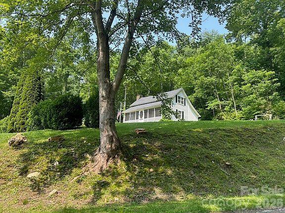 12 Chigger Ridge Road Sylva, NC 28779 - Photo 25 of 28 a house with green field in front of it