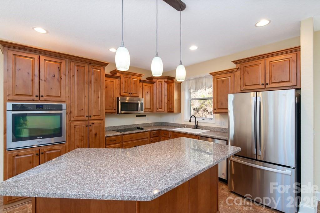 12 Chigger Ridge Road Sylva, NC 28779 - Photo 8 of 28 a kitchen with stainless steel appliances granite countertop a refrigerator a oven and a sink with granite countertops