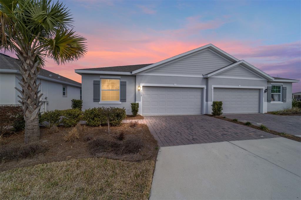 a front view of house with yard and green space