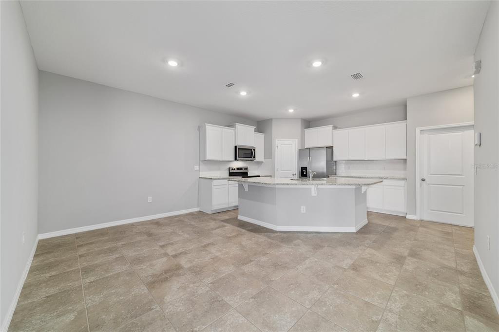 5339 Northwest 46th Ln Road Ocala, FL 34482 - Photo 15 of 79 a view of kitchen with kitchen island a white cabinets and refrigerator