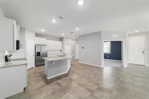 a bathroom with a granite countertop sink a mirror and a toilet