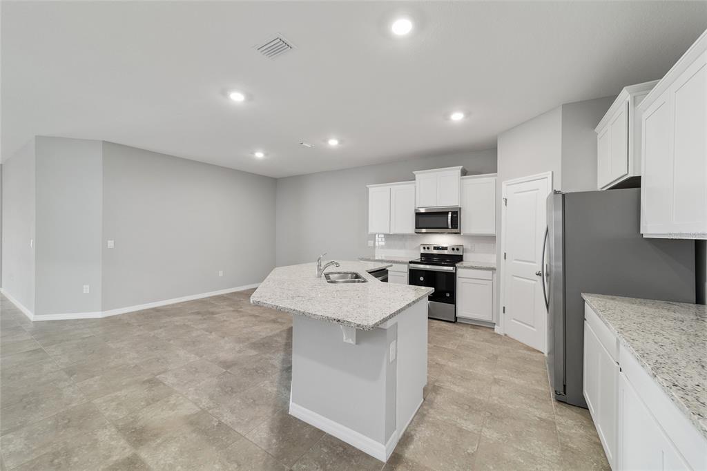5339 Northwest 46th Ln Road Ocala, FL 34482 - Photo 21 of 79 a kitchen with a sink stainless steel appliances and white cabinets
