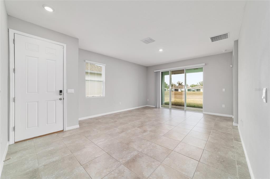 5339 Northwest 46th Ln Road Ocala, FL 34482 - Photo 8 of 79 an empty room with chandelier and windows