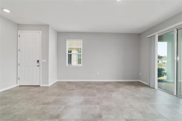 a view of kitchen with kitchen island a white cabinets and refrigerator