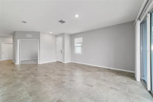 a large kitchen with kitchen island a sink a stove a refrigerator and a cabinets