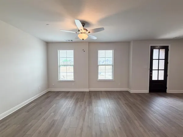 wooden floor in an empty room with a window