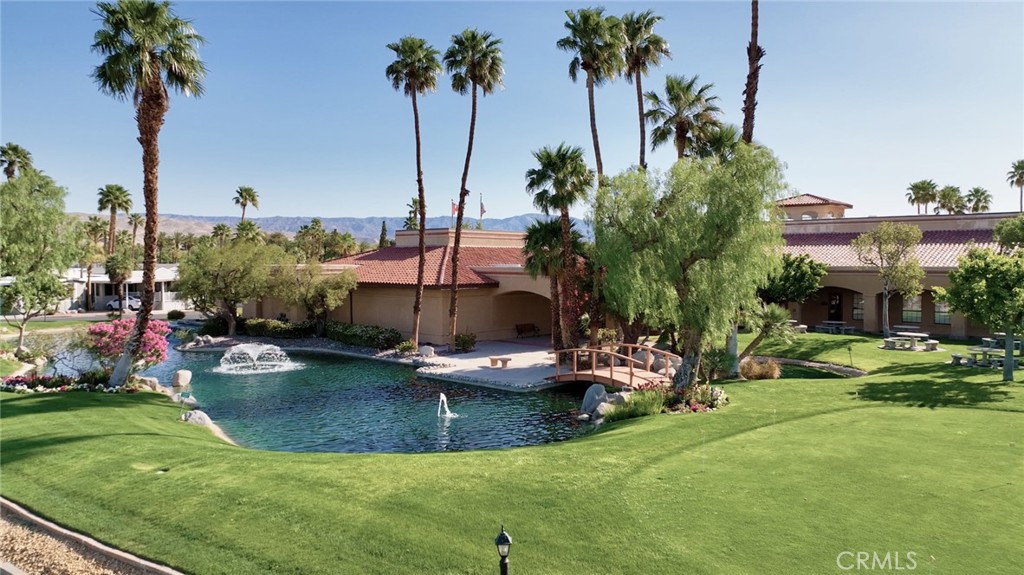 69801 Ramon Road Cathedral City, CA 92234 - Photo 14 of 41 a view of a swimming pool and lounge chairs