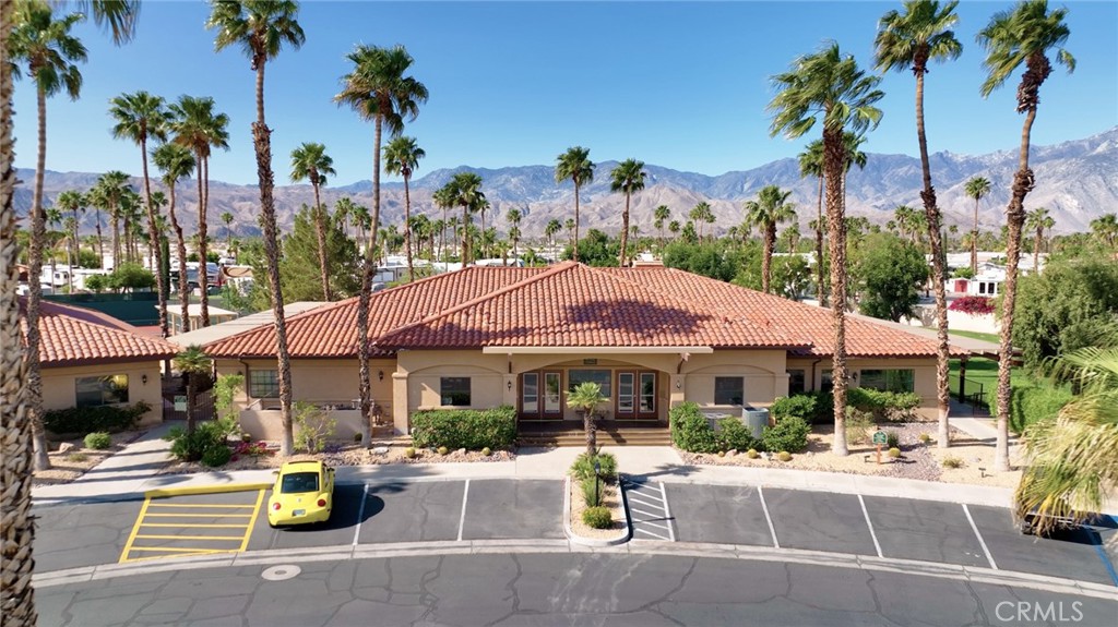 69801 Ramon Road Cathedral City, CA 92234 - Photo 30 of 41 a view of a patio with a table and chairs under an umbrella
