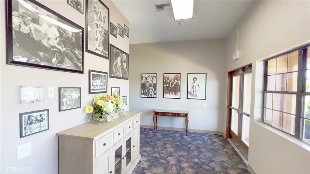 69801 Ramon Road Cathedral City, CA 92234 - Photo 31 of 41 a hallway with painting and wooden floor