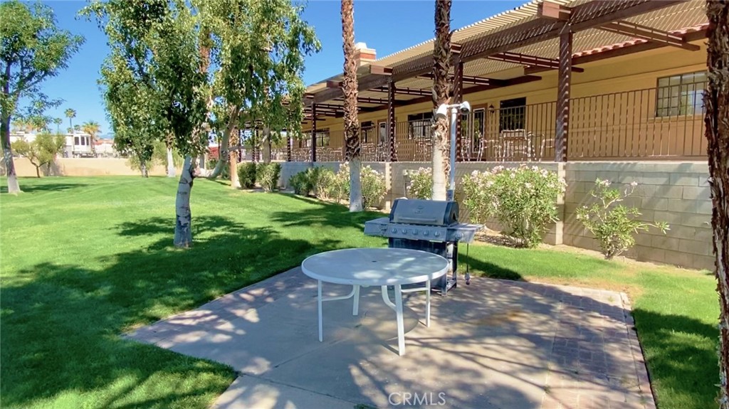 69801 Ramon Road Cathedral City, CA 92234 - Photo 34 of 41 a view of a patio with a table and chairs
