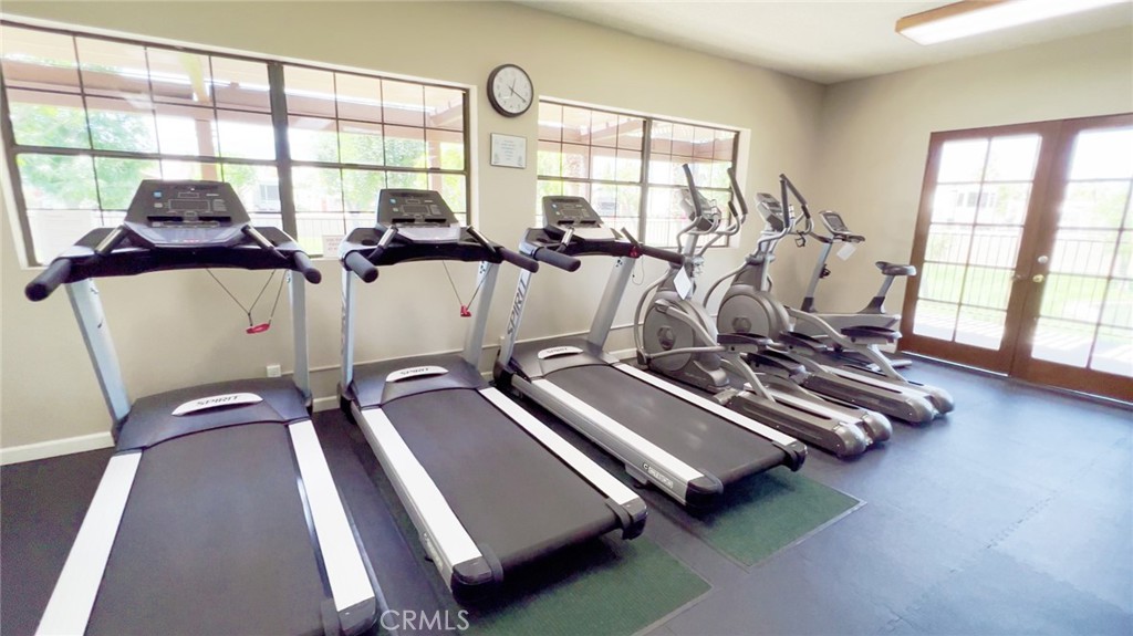 69801 Ramon Road Cathedral City, CA 92234 - Photo 38 of 41 a room with gym equipment and large windows