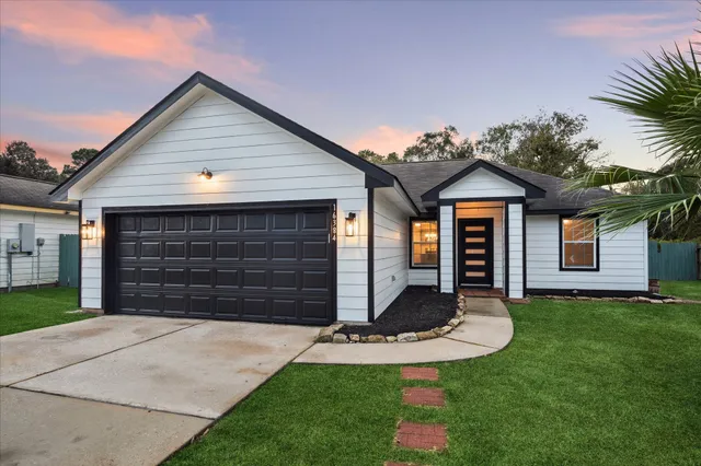 a front view of a house with a yard and garage