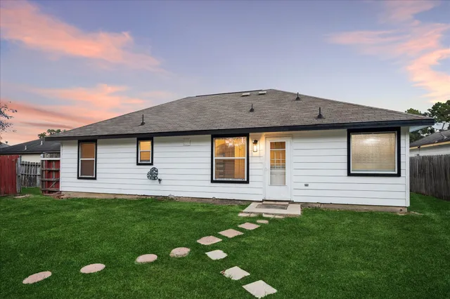 a front view of house with yard and green space