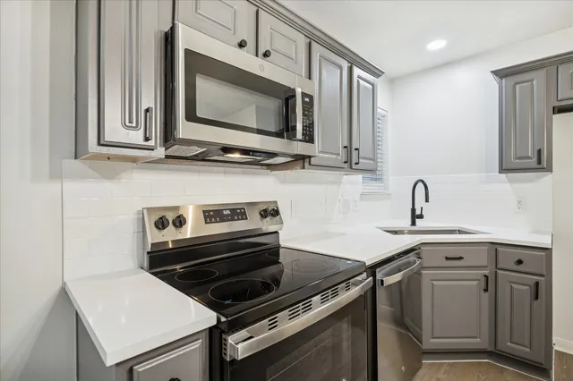 a kitchen with a stove and a microwave
